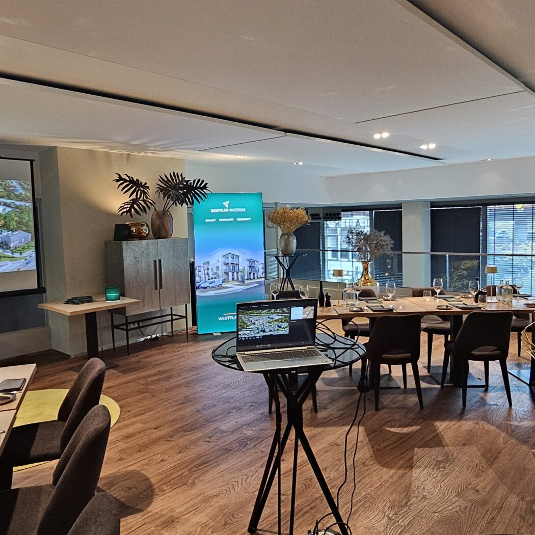 Stijlvolle presentatieruimte met projectiescherm waarop Accent Marietta Atlanta staat, blauwgroene banner met logo en gedekte tafels.